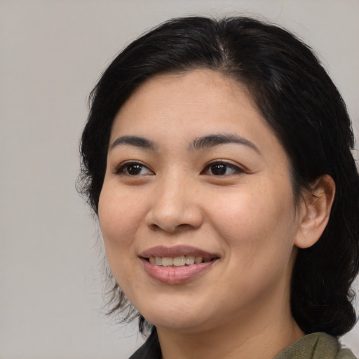 Joyful asian young-adult female with medium  black hair and brown eyes