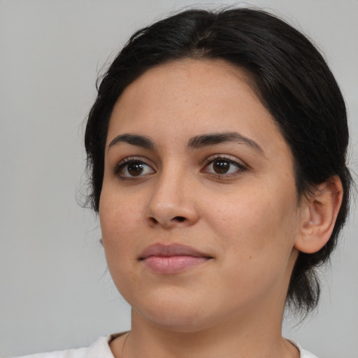 Joyful latino young-adult female with medium  black hair and brown eyes