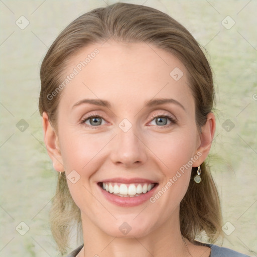 Joyful white young-adult female with medium  brown hair and green eyes