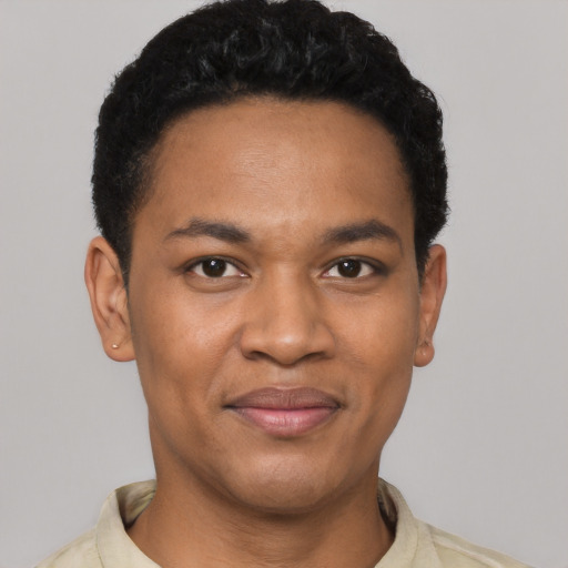 Joyful black young-adult male with short  black hair and brown eyes