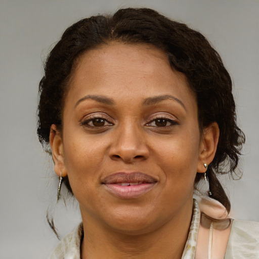 Joyful black young-adult female with medium  brown hair and brown eyes