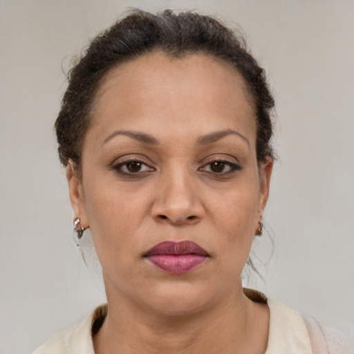 Joyful latino adult female with short  brown hair and brown eyes