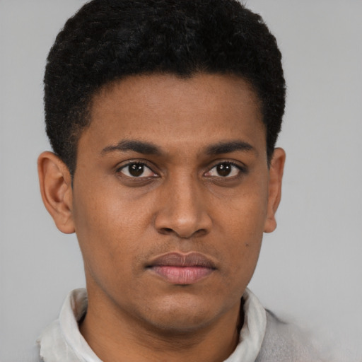 Joyful latino young-adult male with short  brown hair and brown eyes