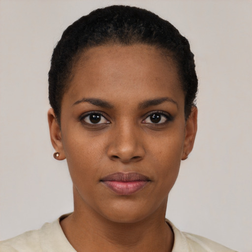 Joyful black young-adult female with short  black hair and brown eyes