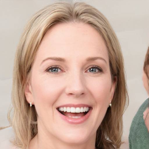 Joyful white young-adult female with medium  brown hair and blue eyes