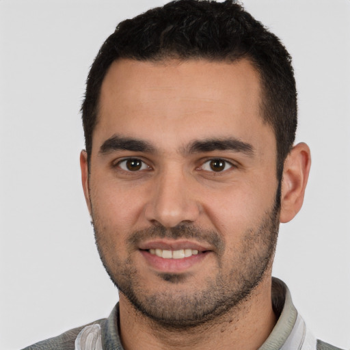 Joyful white young-adult male with short  black hair and brown eyes