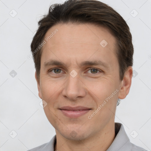 Joyful white adult male with short  brown hair and brown eyes