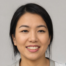 Joyful asian young-adult female with medium  black hair and brown eyes