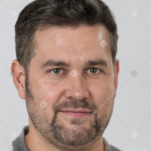 Joyful white adult male with short  brown hair and brown eyes