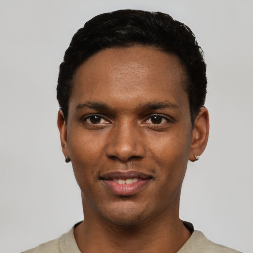 Joyful black young-adult male with short  black hair and brown eyes
