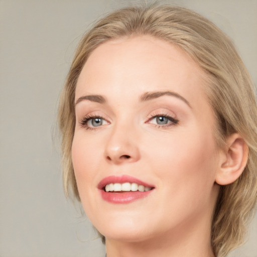 Joyful white young-adult female with medium  brown hair and blue eyes