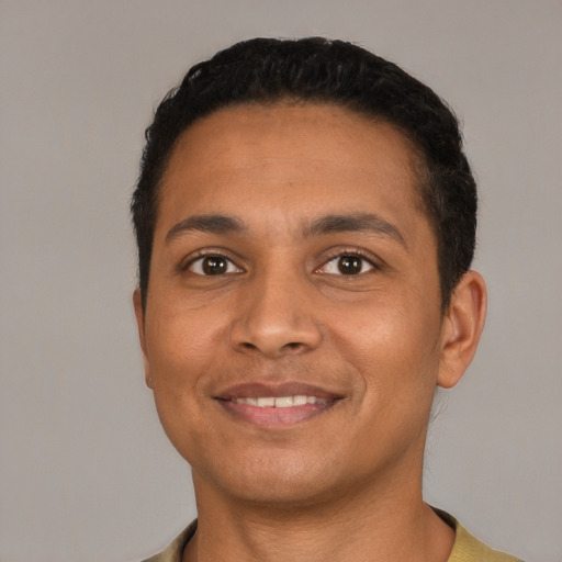 Joyful latino young-adult male with short  black hair and brown eyes