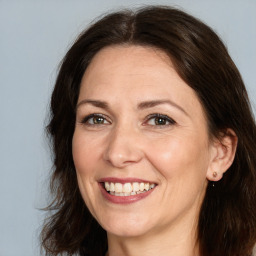 Joyful white adult female with medium  brown hair and brown eyes