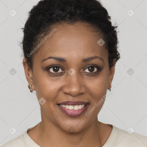 Joyful black young-adult female with short  brown hair and brown eyes