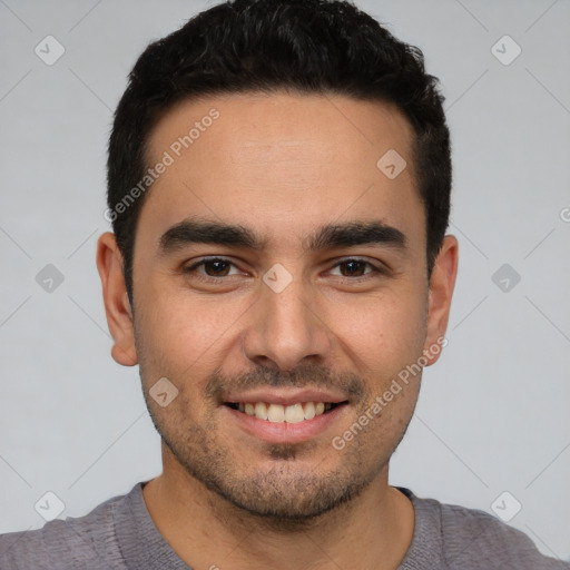 Joyful white young-adult male with short  black hair and brown eyes