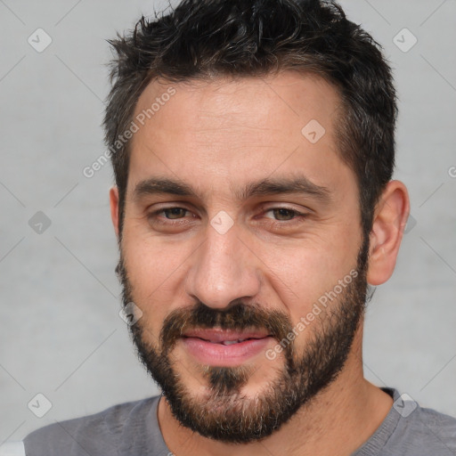 Joyful white adult male with short  brown hair and brown eyes