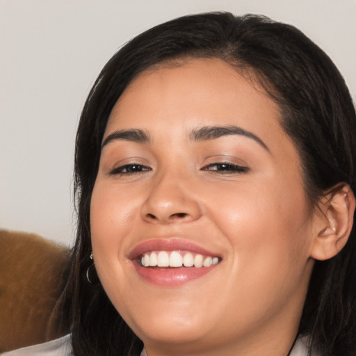 Joyful white young-adult female with long  black hair and brown eyes