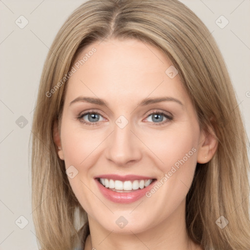 Joyful white young-adult female with long  brown hair and green eyes