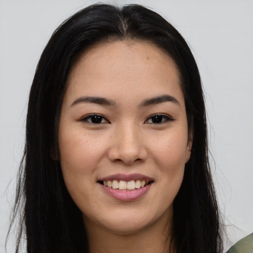 Joyful asian young-adult female with long  brown hair and brown eyes