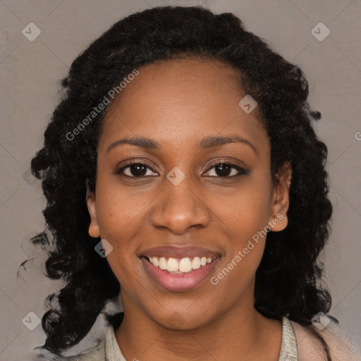 Joyful black young-adult female with long  black hair and brown eyes