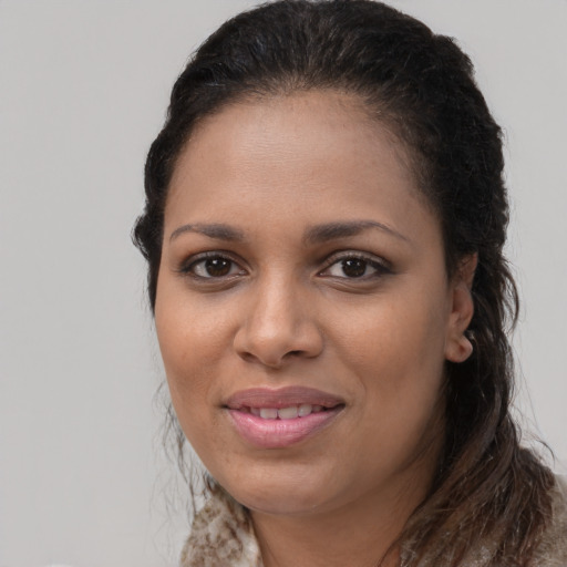Joyful black young-adult female with long  brown hair and brown eyes