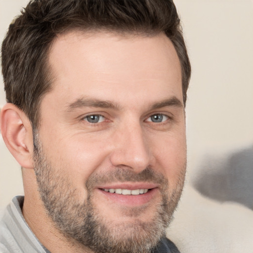 Joyful white adult male with short  brown hair and brown eyes