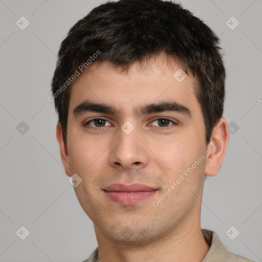 Joyful white young-adult male with short  black hair and brown eyes