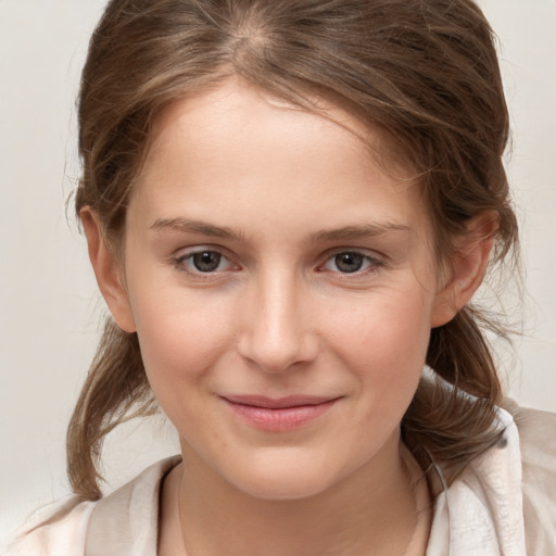 Joyful white child female with medium  brown hair and brown eyes