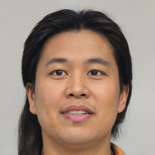 Joyful asian young-adult male with medium  brown hair and brown eyes