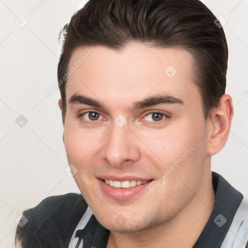 Joyful white young-adult male with short  brown hair and brown eyes