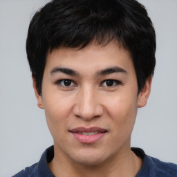 Joyful asian young-adult male with short  black hair and brown eyes