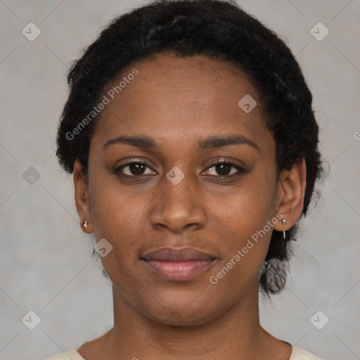 Joyful black young-adult female with short  black hair and brown eyes