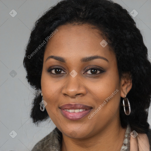 Joyful black young-adult female with long  black hair and brown eyes