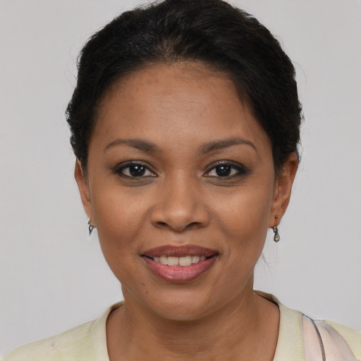 Joyful latino young-adult female with short  brown hair and brown eyes