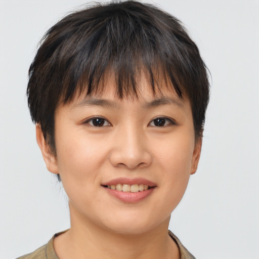 Joyful asian young-adult female with short  brown hair and brown eyes
