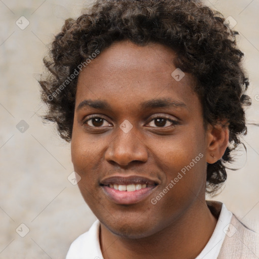 Joyful black young-adult male with short  brown hair and brown eyes