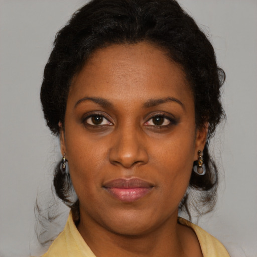 Neutral black young-adult female with medium  brown hair and brown eyes