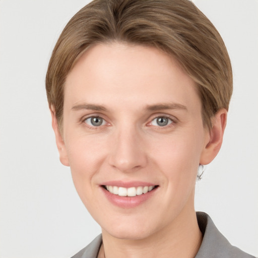 Joyful white young-adult female with short  brown hair and grey eyes