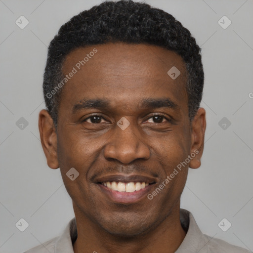 Joyful black young-adult male with short  black hair and brown eyes