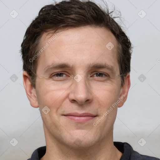 Joyful white adult male with short  brown hair and grey eyes