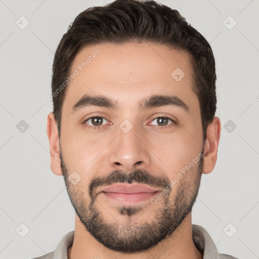 Joyful white young-adult male with short  black hair and brown eyes