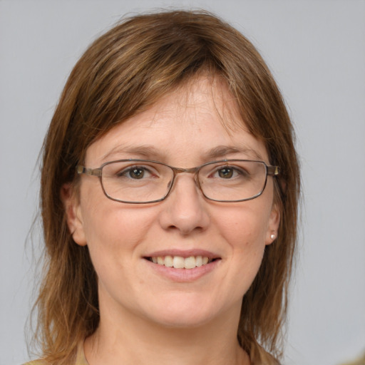 Joyful white adult female with medium  brown hair and blue eyes