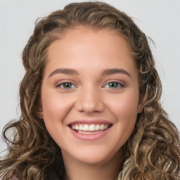 Joyful white young-adult female with long  brown hair and green eyes