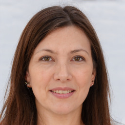 Joyful white adult female with long  brown hair and brown eyes