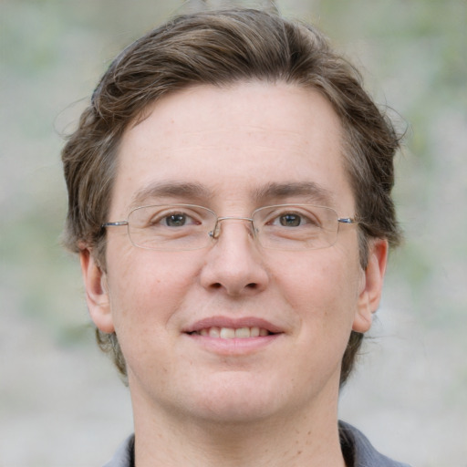 Joyful white adult male with short  brown hair and grey eyes