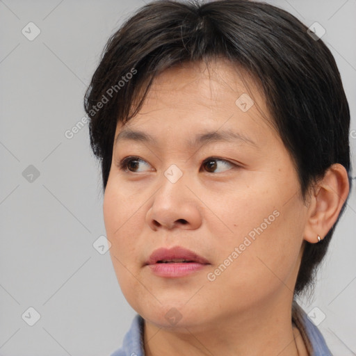 Joyful asian young-adult female with medium  brown hair and brown eyes