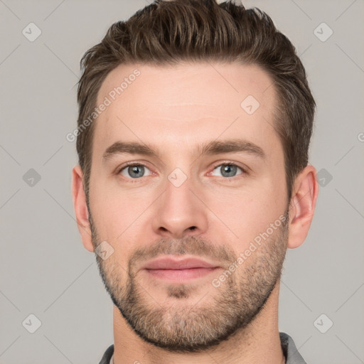 Joyful white young-adult male with short  brown hair and grey eyes