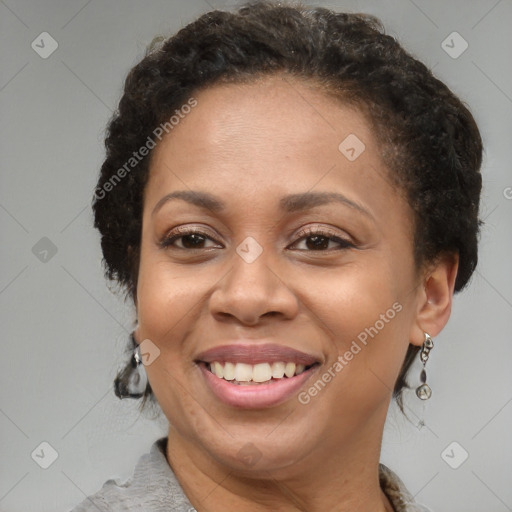 Joyful black adult female with medium  brown hair and brown eyes