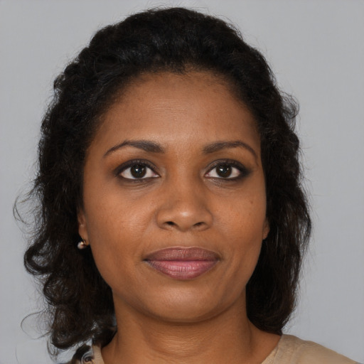 Joyful black young-adult female with medium  brown hair and brown eyes