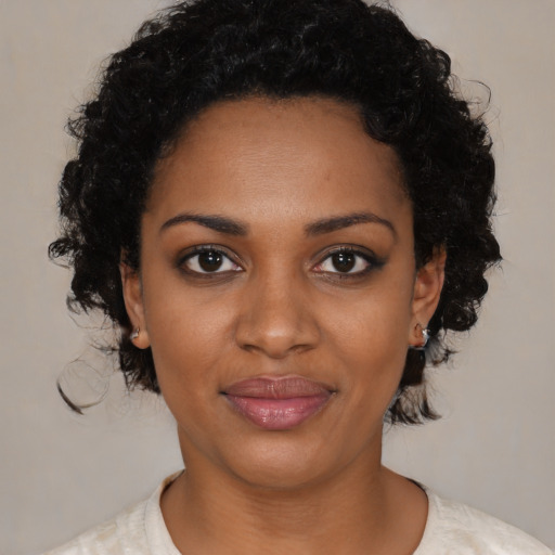 Joyful black young-adult female with medium  black hair and brown eyes